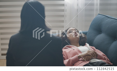 Unhappy teen girl lying on couch, talking to therapist, psychological problem Unhappy teen girl lying on couch, talking to therapist, psychological problem 112842515