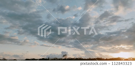 Beautiful twilight and clouds with golden yellow sunlight 112843323