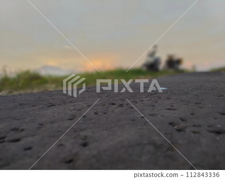 Rural roads are full of grass and quiet in the afternoon Rural roads are full of grass and quiet in the afternoon 112843336