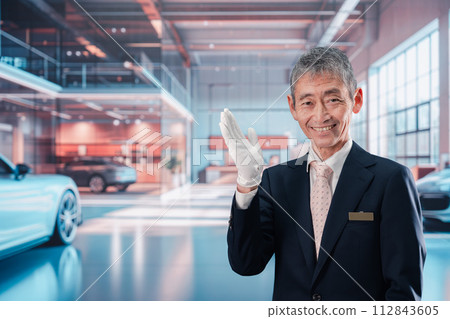 A man serving customers at a car dealership A man serving customers at a car dealership 112843605