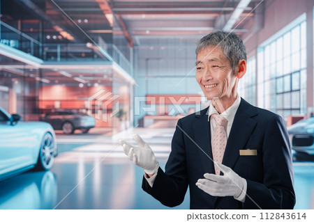 一名男子在汽車經銷店為顧客服務 112843614