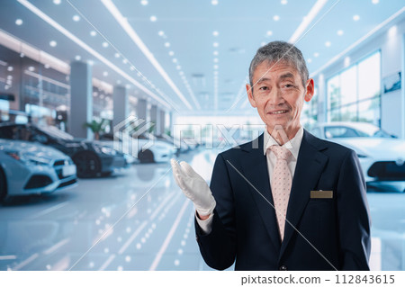 A man serving customers at a car dealership A man serving customers at a car dealership 112843615