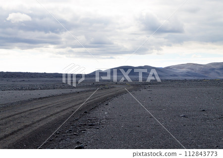 Dirt road along central highlands of Iceland. 112843773