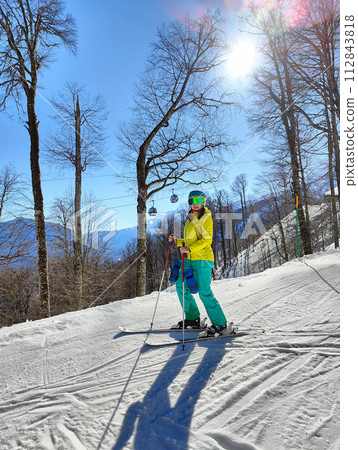 Winter Skier Amidst Snowy Trees and Gondolas 112843818
