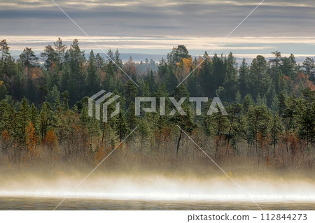 Gorgeous autumn landscape with river and misty forest Gorgeous autumn landscape with river and misty forest 112844273
