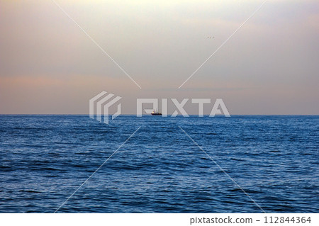 commercial catch fishing far out at sea 112844364