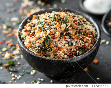 Furikake is a Japanese seasoning made from a mixture of dried and ground ingredients in bowl Furikake is a Japanese seasoning made from a mixture of dried and ground ingredients in bowl 112844535