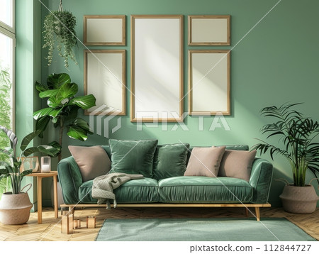 Cozy green sofa and wooden furniture against light green wall with poster frames. 112844727