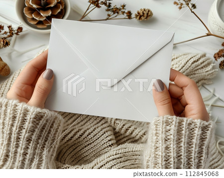 Envelope with in woman's hands on the white background. Mail concept 112845068