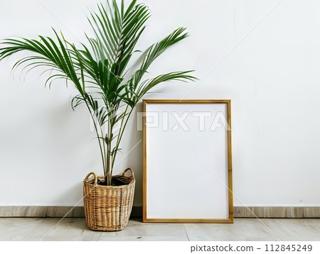 an empty picture frame on the floor, a palm plant is beside it, minimal and modern with a tropical twist an empty picture frame on the floor, a palm plant is beside it, minimal and modern with a tropical twist 112845249