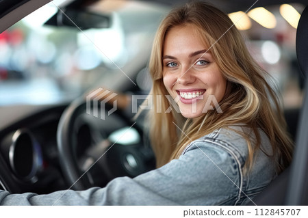Beautiful, caucasian, young happy woman with warm smile driving her car. Close up portrait of female with glad positive expression enjoying travel 112845707
