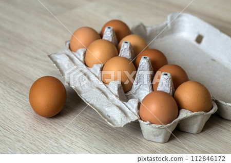 Hen eggs on kitchen table background. Healthy organic food, delicious meal, cholesterol and diet concept. 112846172
