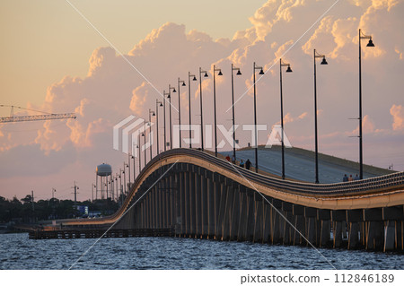Barron Collier Bridge and Gilchrist Bridge in Florida with moving traffic. Transportation infrastructure in Charlotte County connecting Punta Gorda and Port Charlotte over Peace River Barron Collier Bridge and Gilchrist Bridge in Florida with moving traffic. Transportation infrastructure in Charlotte County connecting Punta Gorda and Port Charlotte over Peace River 112846189