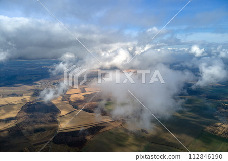 Aerial view from high altitude of earth covered with puffy rainy clouds forming before rainstorm Aerial view from high altitude of earth covered with puffy rainy clouds forming before rainstorm 112846190