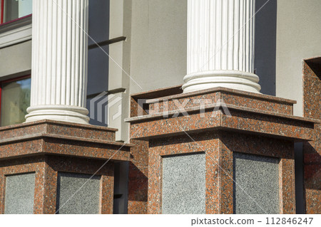 Detail of a house facade. Granite columns as decorative elements of the building. 112846247