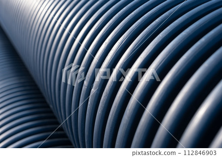 Close-up view on black plastic corrugated drain pipe ribs texture Close-up view on black plastic corrugated drain pipe ribs texture 112846903