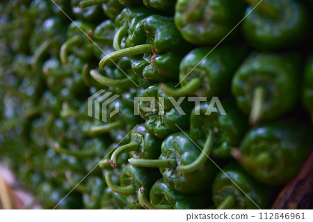 Green pepper on the counter of the Egyptian market. Fresh vegetables in the street bazaar. 112846961