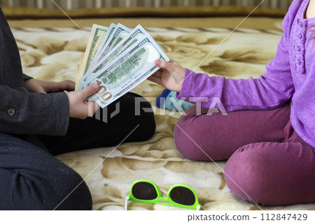 Two little children boy and girl playing with dollars money. Two little children boy and girl playing with dollars money. 112847429