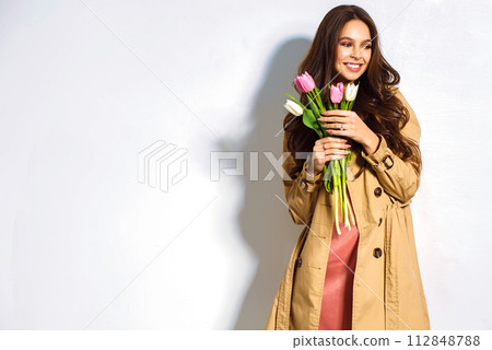 Fashion photo of beautiful woman with tulips in her hand. March 8. beautiful girl in stylish clothes 112848788