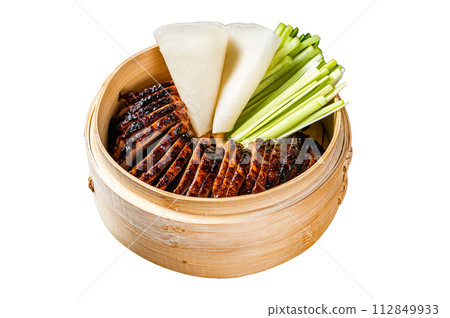 Peking Duck in bamboo steamer served with cucumber, green onion, and wheaten chinese pancakes. Isolated on white background. Top view. 112849933