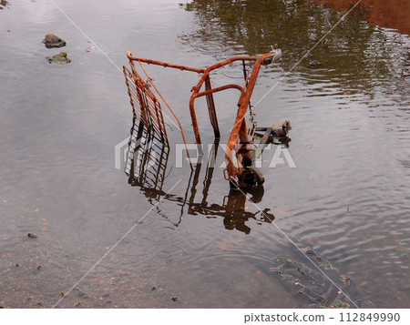 Rusting Shopping Cart in the river Rusting Shopping Cart in the river 112849990