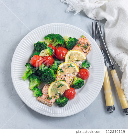 Salmon steak with vegetables, baked salmon fillet with broccoli and tomato, top view, square format 112850119