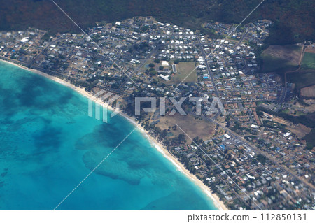 Aerial view of Waimanalo Beach, Homes, bay. Highway, Park and Pacific Ocean Aerial view of Waimanalo Beach, Homes, bay. Highway, Park and Pacific Ocean 112850131