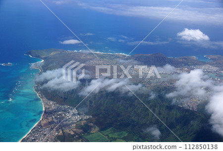 Aerial view of Waimanalo, Rock Island, Hawaii Kai Town, Koko Head Crater, farms, ko'olau range mountains, Kuapa Pond, Hanauma Bay, clouds and Pacific Ocean 112850138