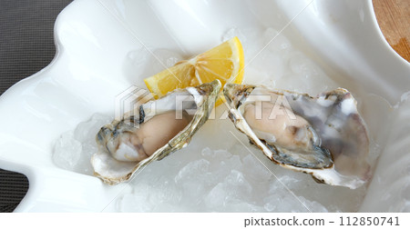 Fresh oyster with slice lemon isolated on white background. High quality photo Fresh oyster with slice lemon isolated on white background. High quality photo 112850741