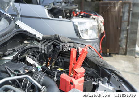 Car battery run-up and first aid Jumping start with booster cable Car battery run-up and first aid Jumping start with booster cable 112851330