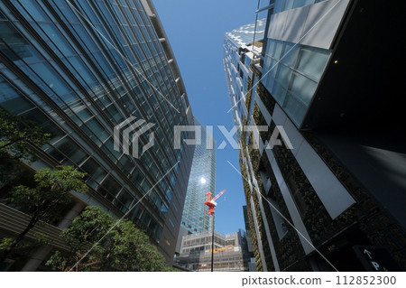 Looking up at the buildings and large cranes in Shibuya Looking up at the buildings and large cranes in Shibuya 112852300