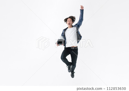 A man jumping with a helmet A man jumping with a helmet 112853630