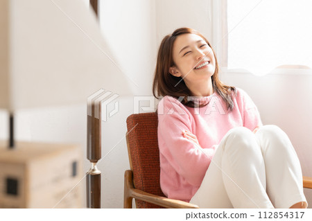 A young woman relaxing in the room A young woman relaxing in the room 112854317