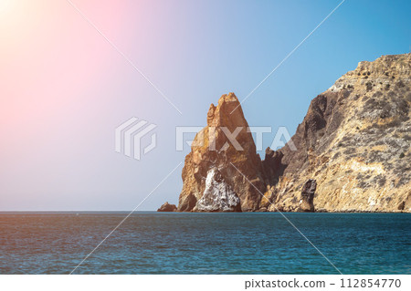 Abstract nature summer ocean sunset sea background. Small waves on water surface in motion blur with bokeh lights from sunrise. Holiday, vacation and recreational background concept 112854770
