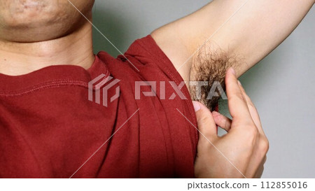 person touching armpit hair person touching armpit hair 112855016