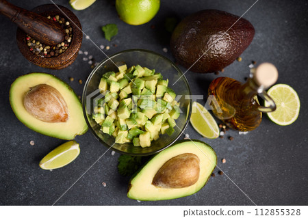 Chopped avocado in glass bowl and avocado Halves Chopped avocado in glass bowl and avocado Halves 112855328