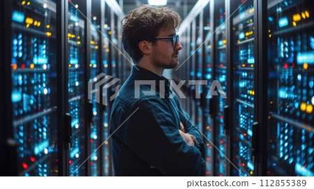 man in the server room watching the server work man in the server room watching the server work 112855389