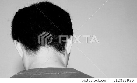 Rear view of a depressed man 112855959