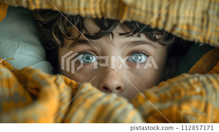 portrait of a frightened child peeking 112857171