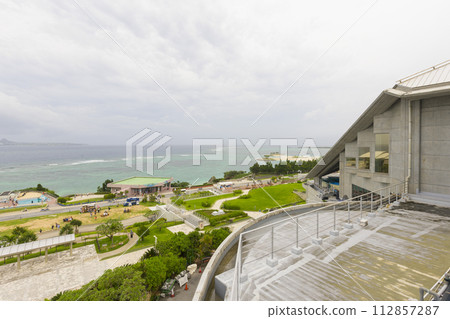 Okinawa Churaumi Aquarium with ocean in the background in Okinawa, Japan Okinawa Churaumi Aquarium with ocean in the background in Okinawa, Japan 112857287