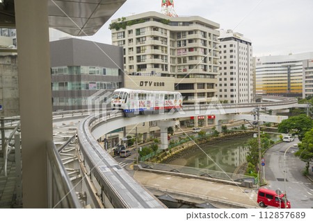 Okinawa, Japan - June 9,2019 : Yui Rail or Okinawa Urban Monorail approaching train station in Okinawa, Japan on June 9,2019. Okinawa, Japan - June 9,2019 : Yui Rail or Okinawa Urban Monorail approaching train station in Okinawa, Japan on June 9,2019. 112857689