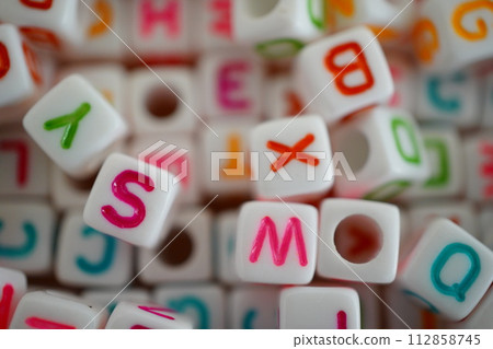Many colorful beads. alphabet beads. Many colorful beads. alphabet beads. 112858745