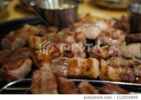 Grilled pork belly on the grill in the restaurant Grilled pork belly on the grill in the restaurant 112858899