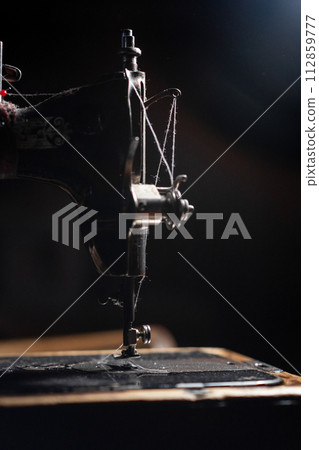 Old sewing machine stands on the table at home ready to work and sew. 112859777