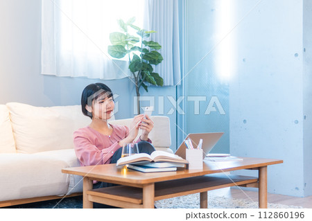 A woman studying at home/working remotely A woman studying at home/working remotely 112860196