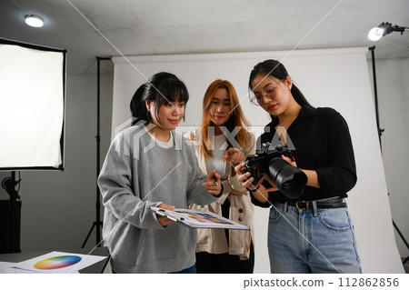 Beautiful creative female freelancer working at modern photography studio Beautiful creative female freelancer working at modern photography studio 112862856
