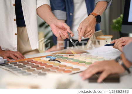 Group of designers of interior choosing material samples, working together at creative office 112862883