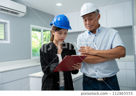 Senior home inspector checking home defects and teaching young engineers, before handing it over to client. Young engineers learn home inspection with Senior, Real estate, and renovation concepts. Senior home inspector checking home defects and teaching young engineers, before handing it over to client. Young engineers learn home inspection with Senior, Real estate, and renovation concepts. 112863555