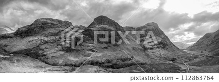Super panorama reveals Three Sisters' contours from a drone, with Glen Coe below dramatic sky 112863764