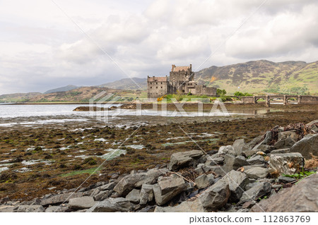 Framed by highlands and an arching bridge, Eilean Donan Castle captures Scotland timeless allure Framed by highlands and an arching bridge, Eilean Donan Castle captures Scotland timeless allure 112863769